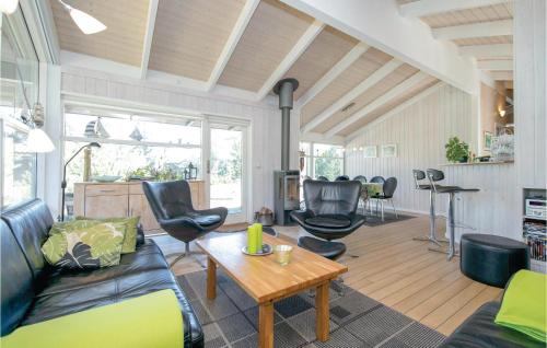 a living room with a couch and chairs and a table at Holiday Home Odde Naturpark Vi in Helberskov