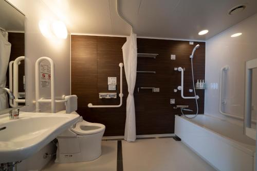 a bathroom with a toilet and a sink and a shower at Grand Inn Higashi-Okazaki in Okazaki