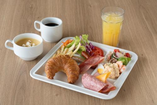 a tray of food with a plate of food with a drink at Grand Inn Higashi-Okazaki in Okazaki