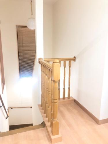 a staircase in a home with white walls and wooden floors at Upper Hotel Ryogoku in Tokyo