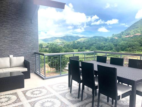 a patio with a table and chairs on a balcony at Bella Villa Coron in Coron
