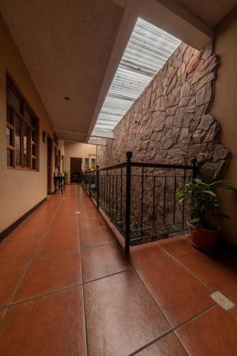 a hallway of a building with a stone wall at 7 orejas in Quetzaltenango