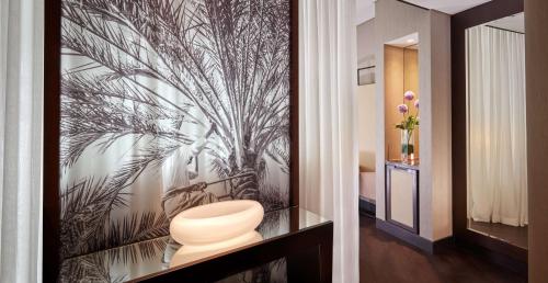 a bathroom with a wall mural of a palm tree at Grand Hyatt Abu Dhabi Hotel & Residences Emirates Pearl in Abu Dhabi