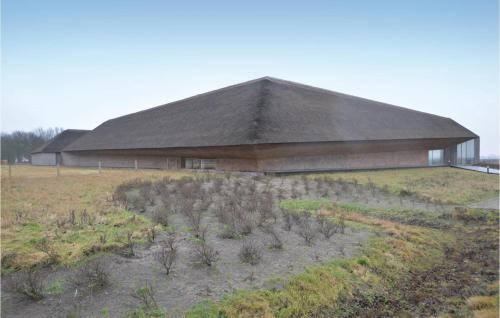 a building with a plot of plants in a field at One-Bedroom Holiday Home In Ribe in Ribe