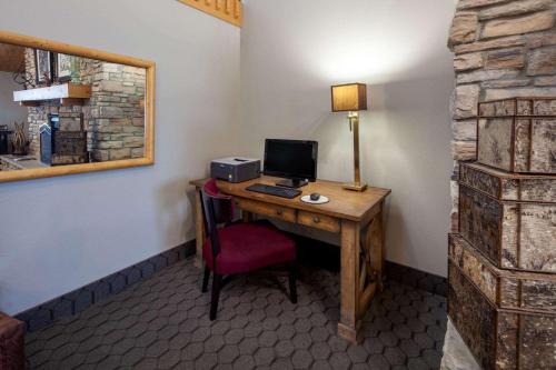 a room with a desk with a computer on it at AmericInn by Wyndham Northfield in Northfield