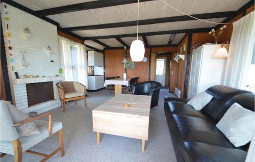 a living room with a couch and a table at Three-Bedroom Holiday Home In Hurup Thy in Doverodde