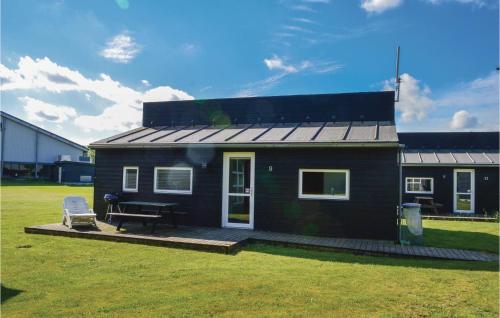 a small house with a picnic table in a yard at Holiday Home Halvejen Hytte Spjald Xii in Spjald