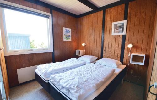 a bedroom with a large bed with a window at Three-Bedroom Holiday Home In Hurup Thy in Doverodde