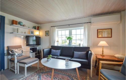 a living room with a couch and a table at Holiday Home Lakolk Rømø Denm in Bolilmark