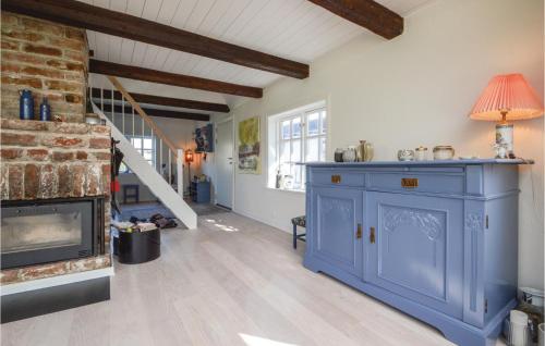 a living room with a blue cabinet and a fireplace at Two-Bedroom Holiday Home In Haderslev in Haderslev