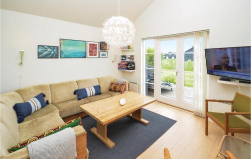 a living room with a couch and a table at Three-Bedroom Holiday Home In Nysted in Nysted