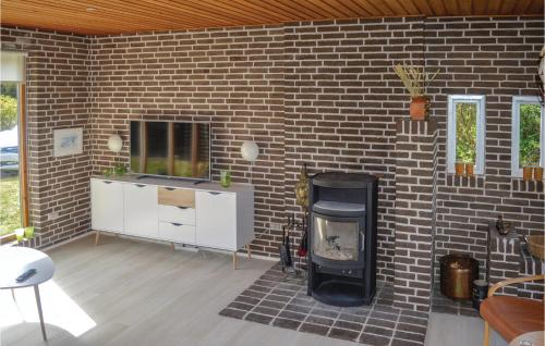 a brick wall with a fireplace in a living room at Three-Bedroom Holiday Home In Saby in Sæby