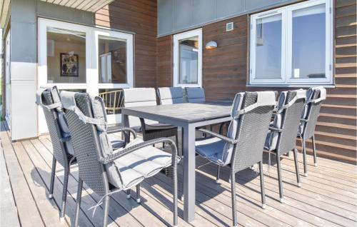 a patio with a table and chairs on a deck at Holiday Home Mosegården Faaborg Iv in Faaborg