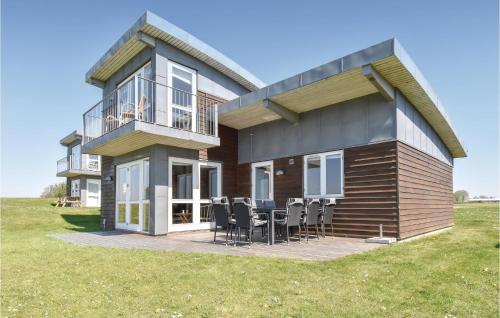 a house with a deck with a table and chairs at Holiday Home Mosegården Faaborg Iv in Faaborg