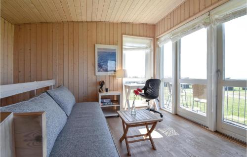 a living room with a couch and a chair at Holiday Home Mosegården Faaborg Iv in Faaborg