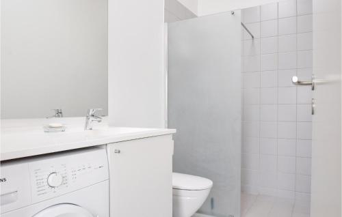 a white bathroom with a toilet and a shower at 2 Bedroom Cozy Home In Tranekr in Hou