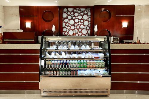 a drink cart in a store with drinks and shoes at أسوار للشقق المخدومة in Al Khobar