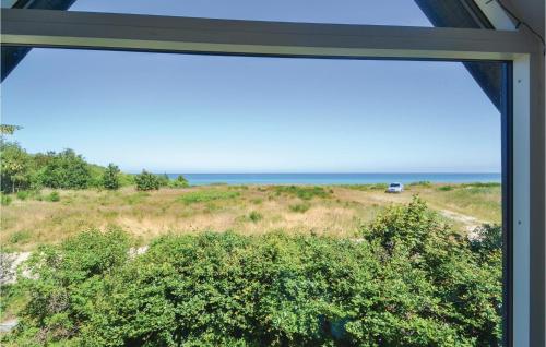 a window view of the ocean from a house at 6 Bedroom Stunning Home In Grenaa in Grenå