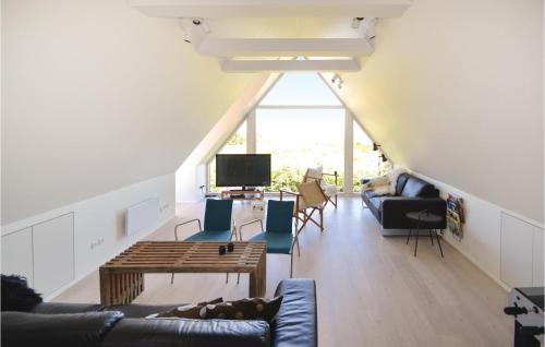 a living room with a couch and chairs and a tv at 6 Bedroom Stunning Home In Grenaa in Grenå