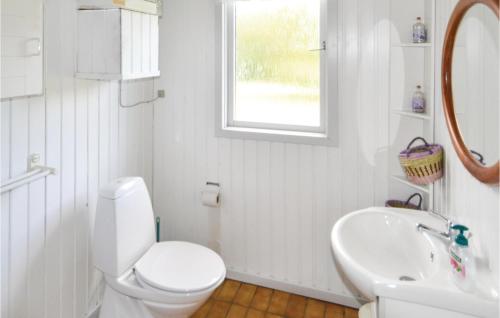 a white bathroom with a toilet and a sink at Awesome Home In rsted With Kitchen in Kare