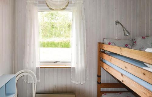 a bedroom with a bed and a window at Awesome Home In rsted With Kitchen in Kare