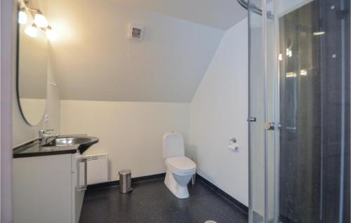 a bathroom with a toilet and a sink and a shower at Holiday Home Rømø 57 in Bolilmark