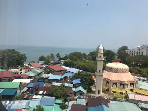 an overhead view of a city with a mosque at By The Sea Beach Front Apartment in Batu Ferringhi