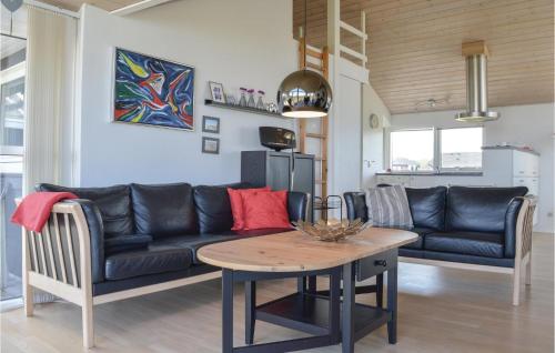 a living room with a couch and a table at Holiday Home Astersvej in Lemvig