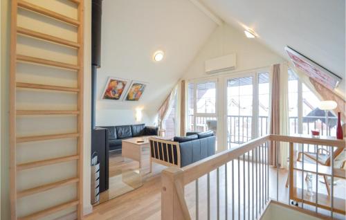 a living room with a stairway leading to a living room at Holiday Home Rømø 57 in Bolilmark