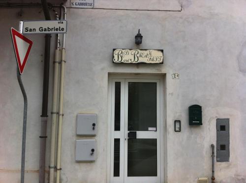 a building with a sign above a door at B&B L'Ormeggio in Monfalcone