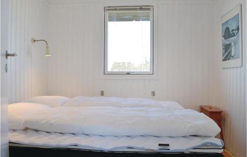 a large white bed in a room with a window at Tina in Klegod