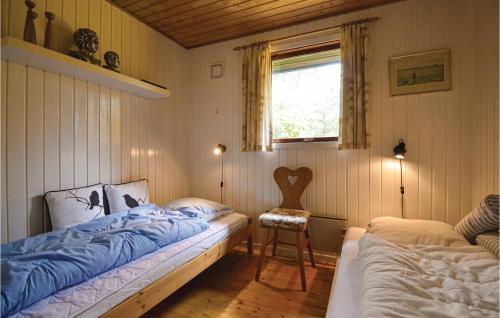 エーベルトフトにあるAmazing Home In Ebeltoft With 3 Bedrooms And Wifiのベッドルーム1室(ベッド2台、窓、椅子付)