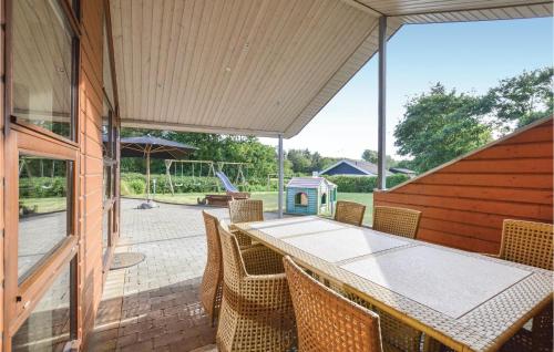 an outdoor patio with a table and chairs at Three-Bedroom Holiday Home In Vinderup in Vinderup