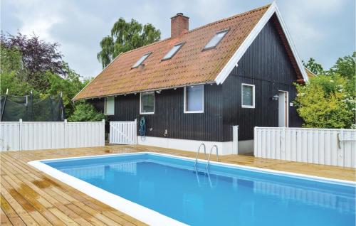 a house with a swimming pool in front of a house at Four-Bedroom Holiday Home In Grasted in Græsted