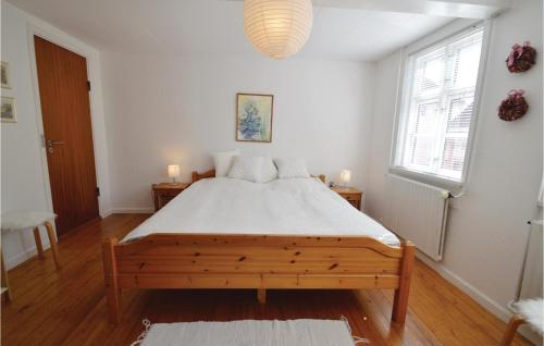 a bedroom with a large wooden bed in a room at 2 Bedroom Gorgeous Home In Nysted in Nysted