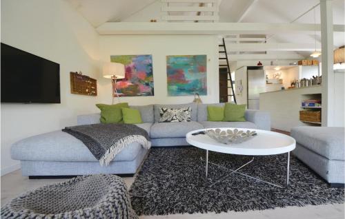 a living room with a couch and a table at Holiday Home Havhusevej Hornslet Denm in Hornslet