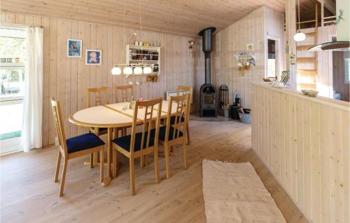 a kitchen and dining room with a table and chairs at Holiday Home Ingerslevvej Gørlev Vi in Reersø