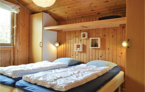 Bjerregårdにある3 Bedroom Cozy Home In Hvide Sandeのベッド2台 木製の壁の部屋