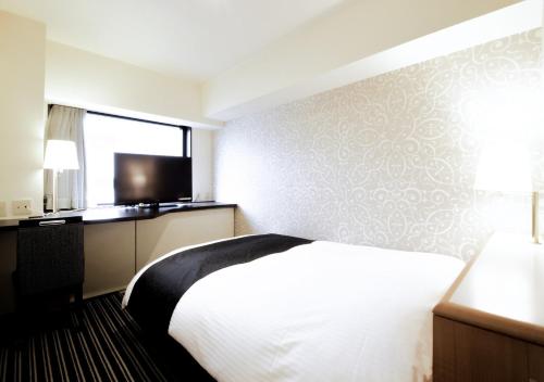 Postel nebo postele na pokoji v ubytování APA Hotel Tokyo Ojima
