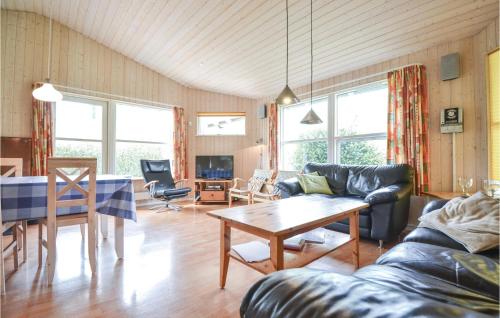 a living room with a couch and a table at Holiday Home Bækholmen Ebeltoft V in Ebeltoft