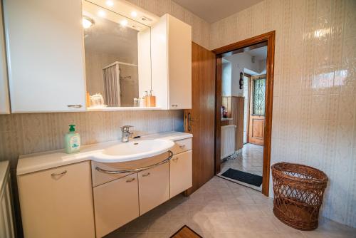 a bathroom with a sink and a mirror at Holiday Home Mountain View in Ljubno