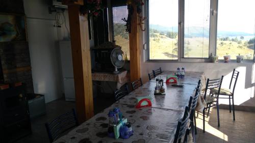 a dining room with a long table and chairs at Айрови in Sarnitsa