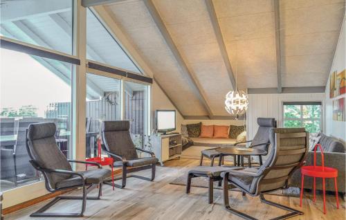 a room with chairs and a table and a couch at Three-Bedroom Holiday Home In Hvide Sande in Bjerregård