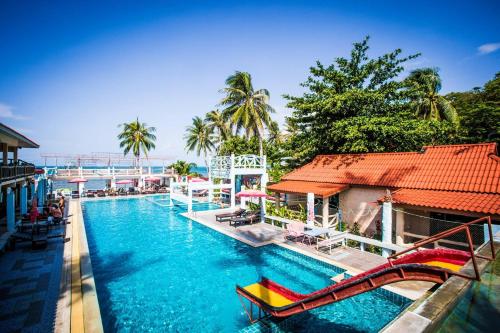 a pool at a resort with a slide in it at Paradise Bungalows in Haad Rin