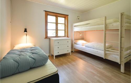 a bedroom with two bunk beds and a window at Stunning Home In Torrig L With House Sea View in Torrig