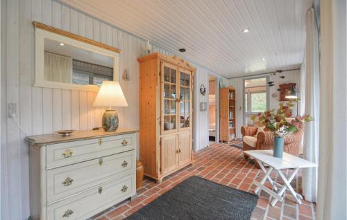 a kitchen with a dresser and a table with a lamp at Holiday Home Romo Lxx in Toftum