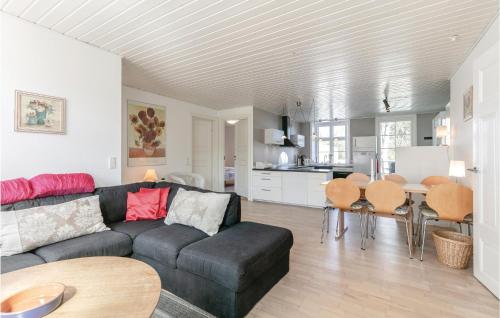 a living room with a couch and a table at Buskegaard in Østermarie