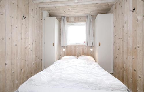 a white bed in a room with a window at Cozy Home In Lkken With Kitchen in Løkken