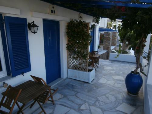 a patio with chairs and a blue door at Galini Bungalows in Kionia