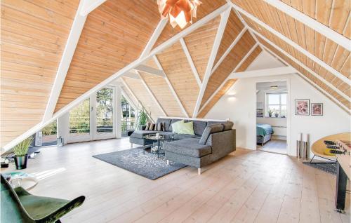 an attic living room with a vaulted ceiling at Holiday Home Mimosavej Ebeltoft Iii in Ebeltoft